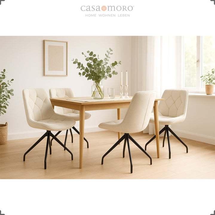Set med 4 stoppade stolar som kan roteras 360° i beige med en svart metallram - ljus matsal med träbord, eukalyptusdekoration och naturlig belysning
