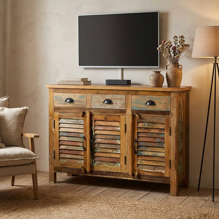 Vintage highboard av massivt trä och gammalt trä med lådor placerade som TV-möbel i vardagsrummet